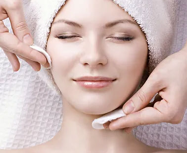 Woman receiving a relaxing facial treatment at Just Be Massage and Wellness